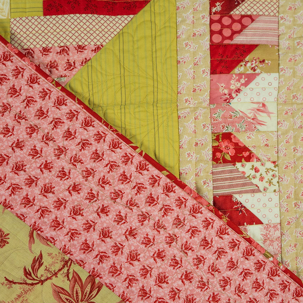 Patchwork fabric with red, green, and pink patterns