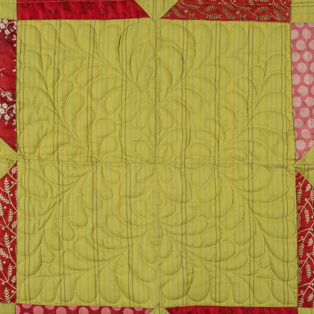 Quilt with green central panel and red and pink border