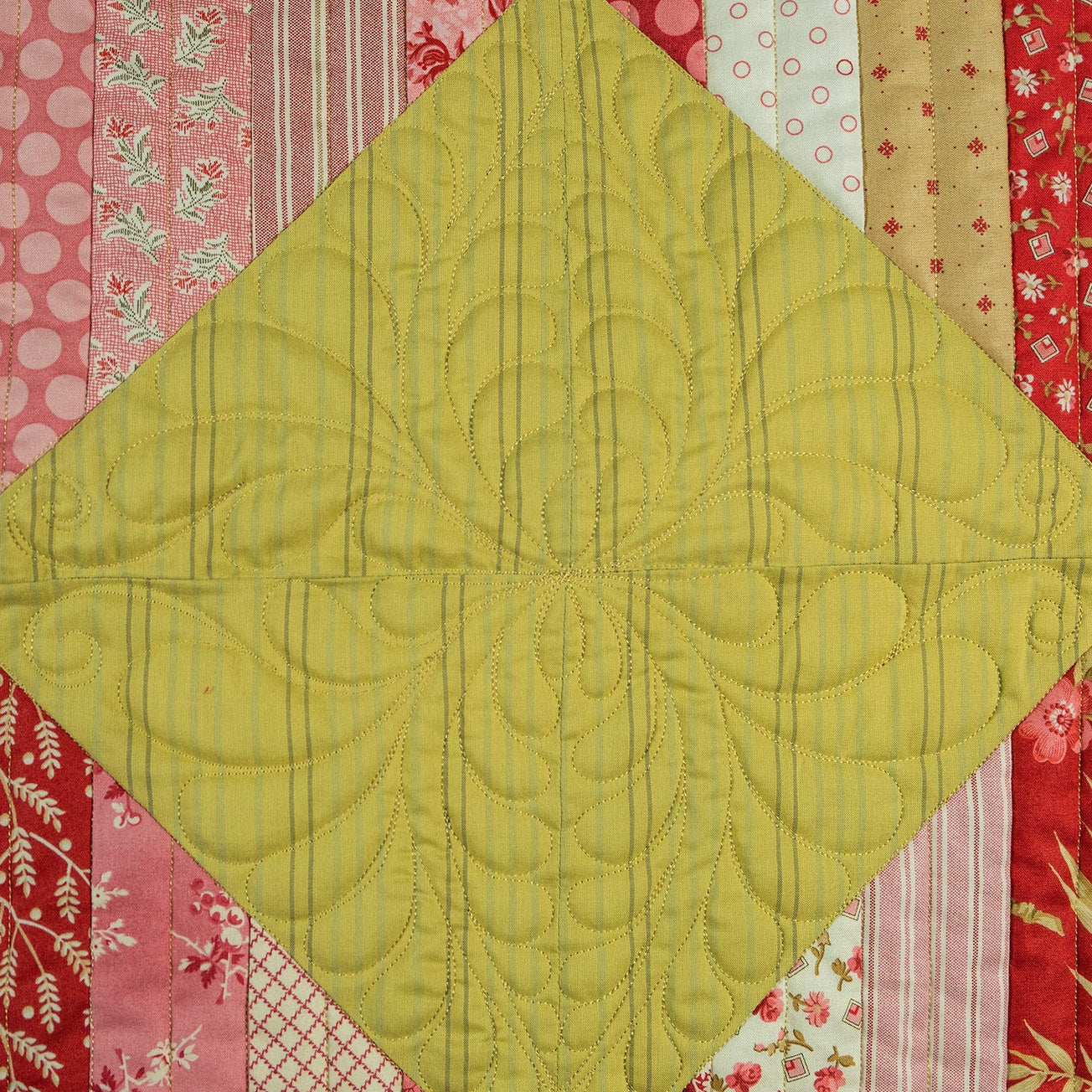 Quilt with green diamond pattern and colorful border