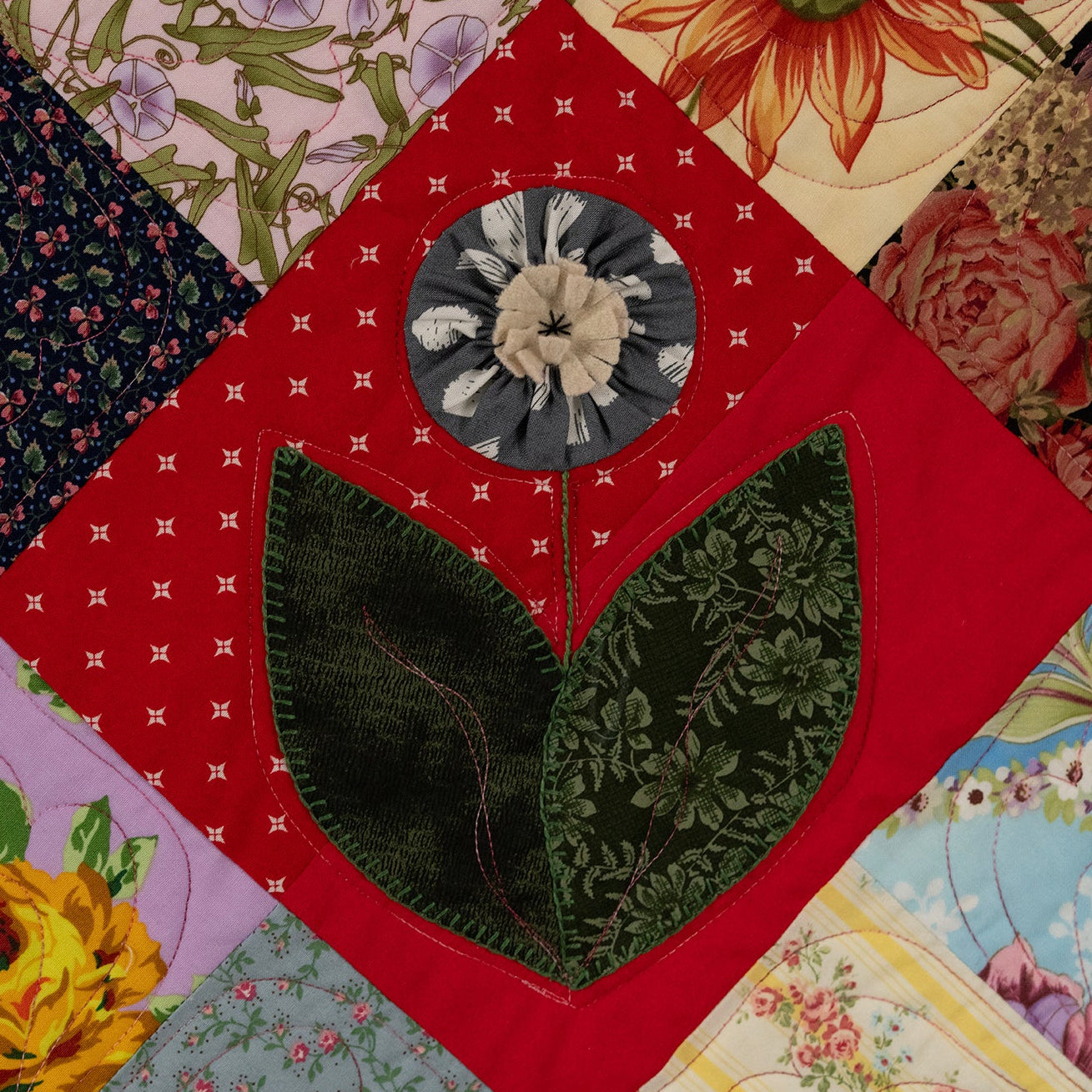 Close-up of a patchwork quilt with floral and geometric patterns