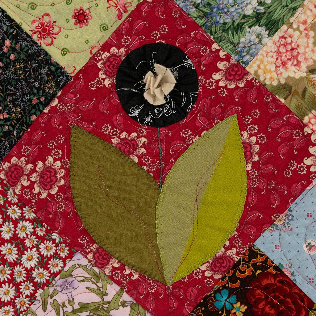 Colorful patchwork quilt with floral and leaf patterns