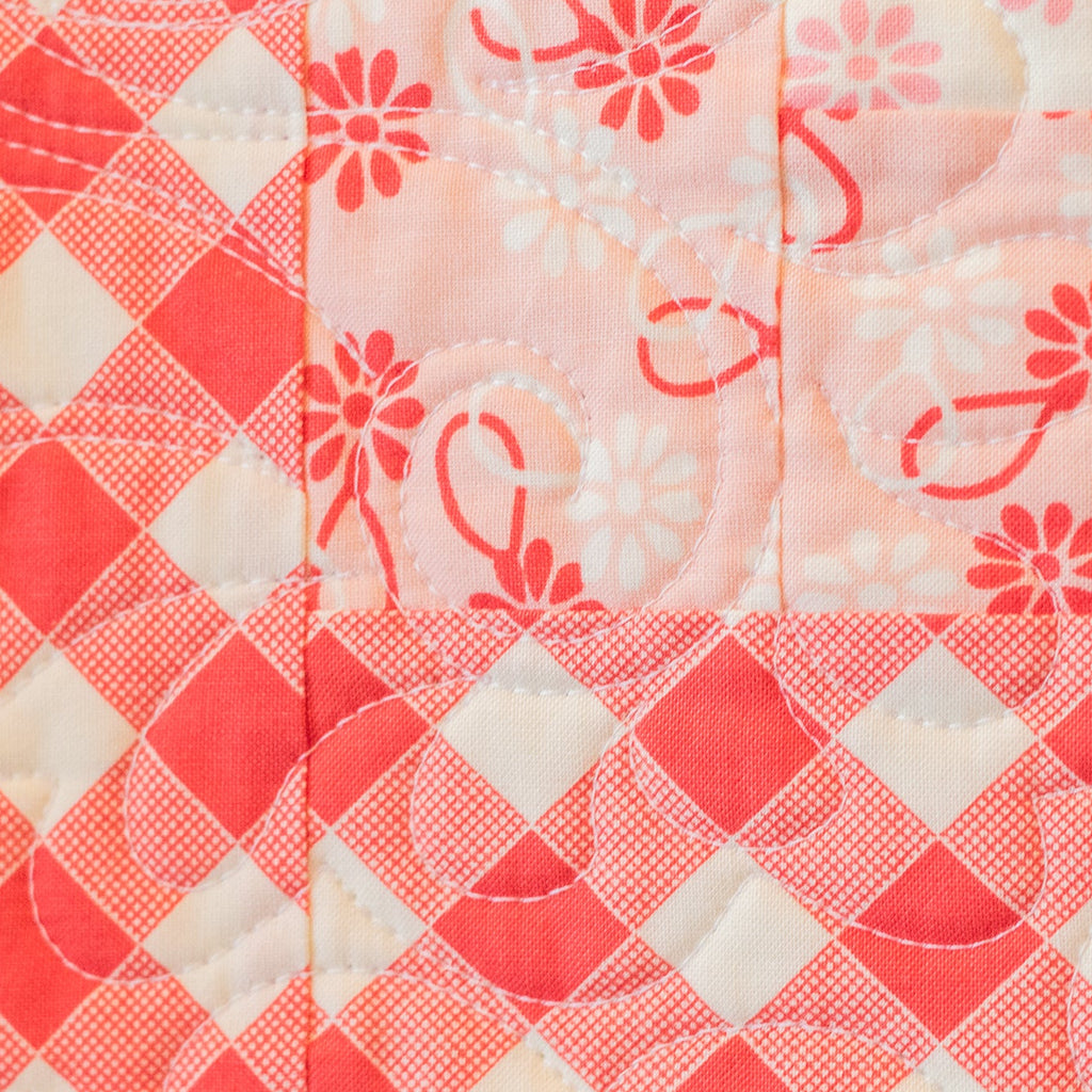 Quilt with red and white floral patterns