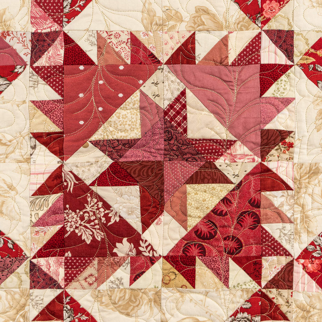 Quilt with red and beige geometric pattern