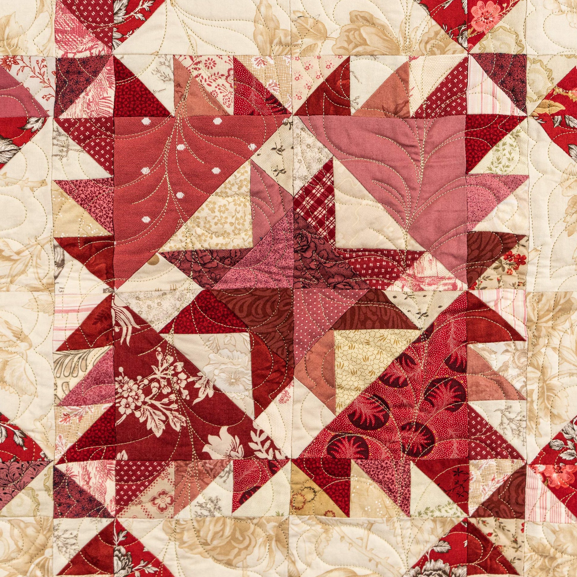 Quilt with red and beige geometric pattern