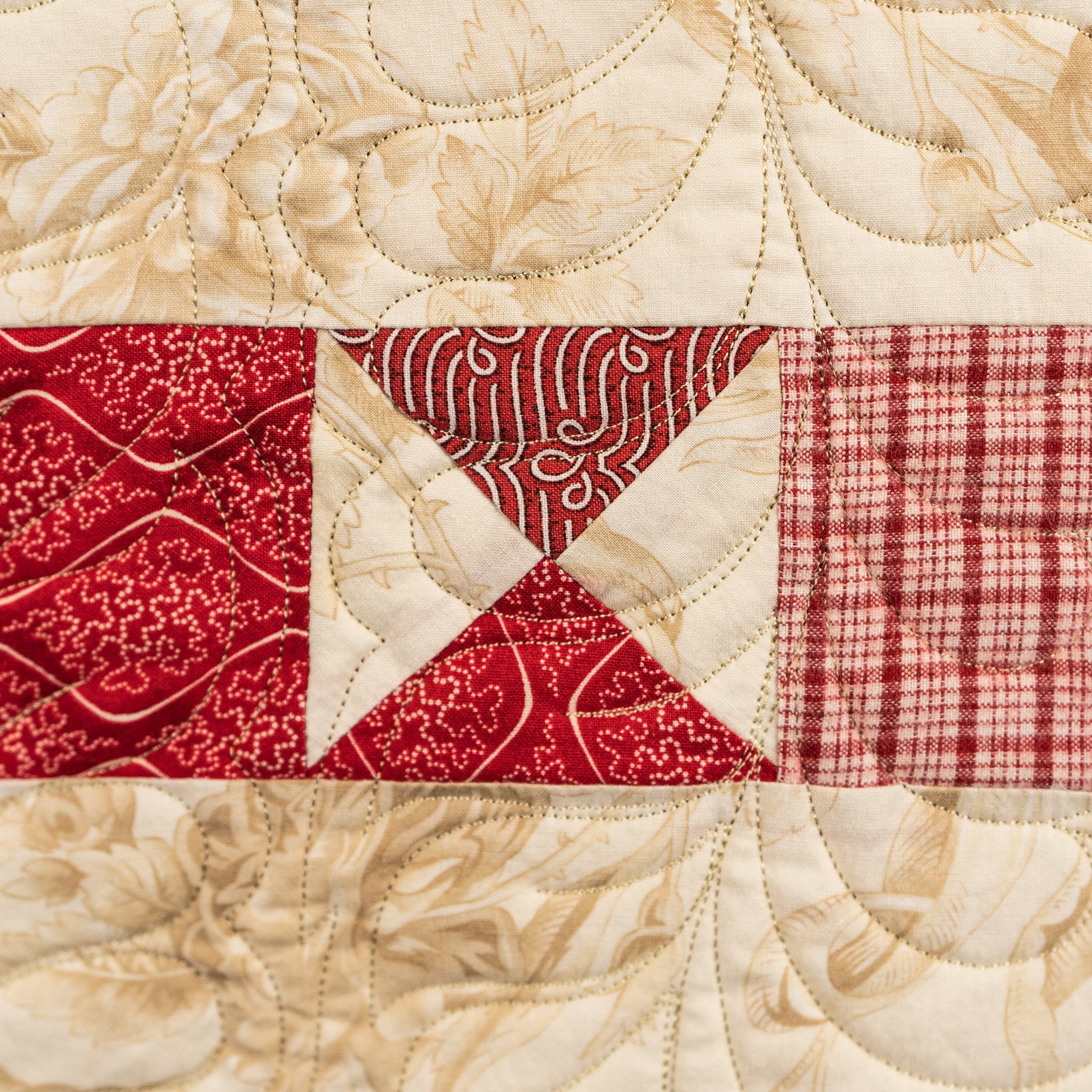 Quilted fabric block with red and beige patterns