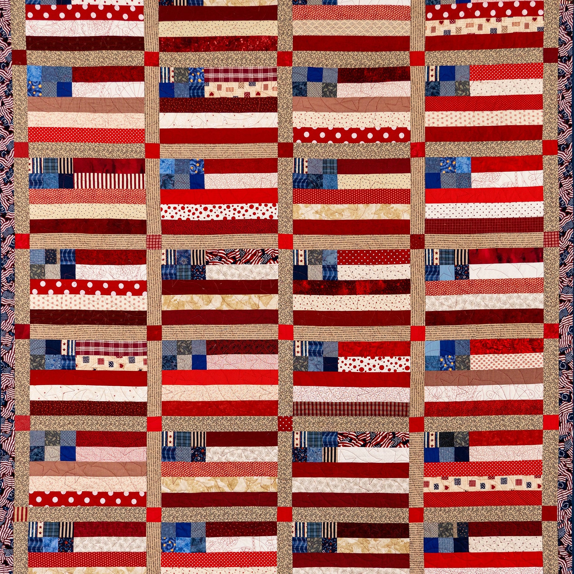 Patchwork quilt with a pattern resembling American flags on a plain background