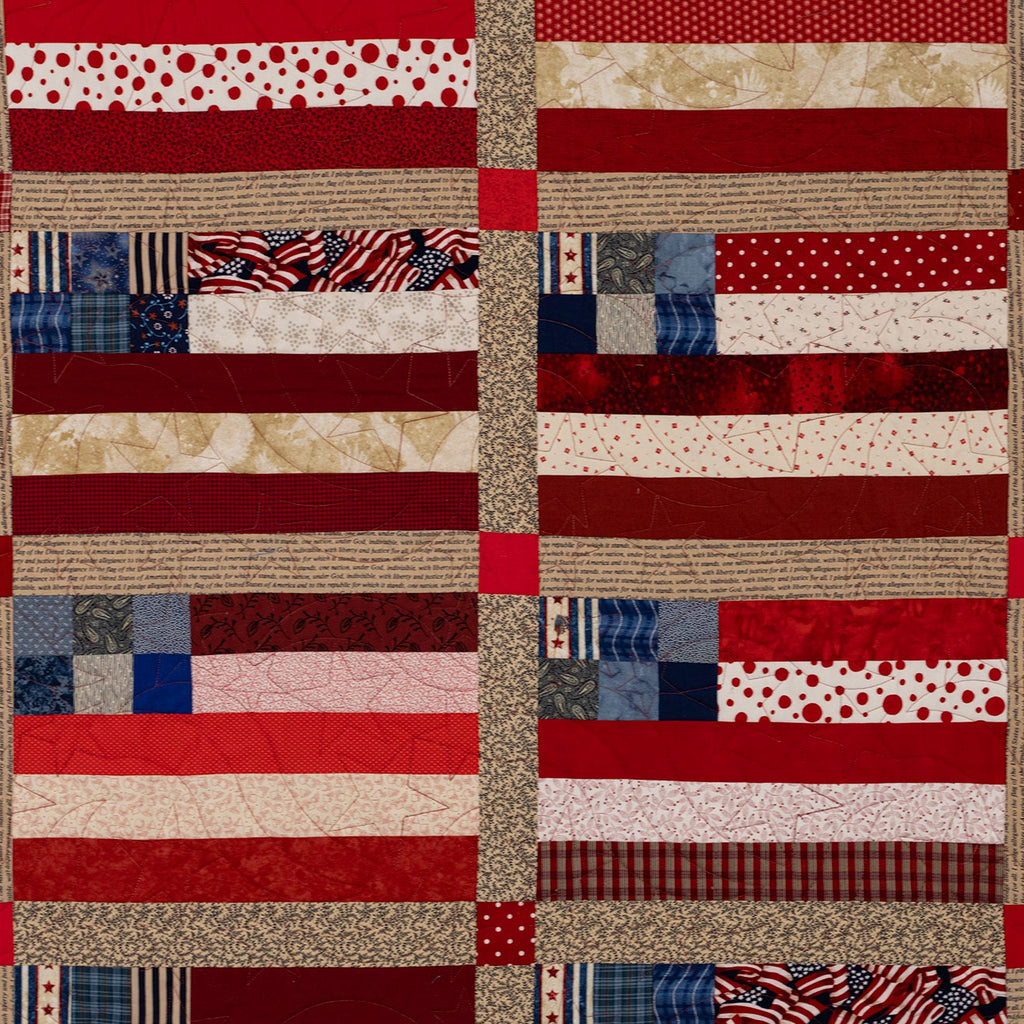 Patchwork quilt with American flag pattern in red, white, and blue.