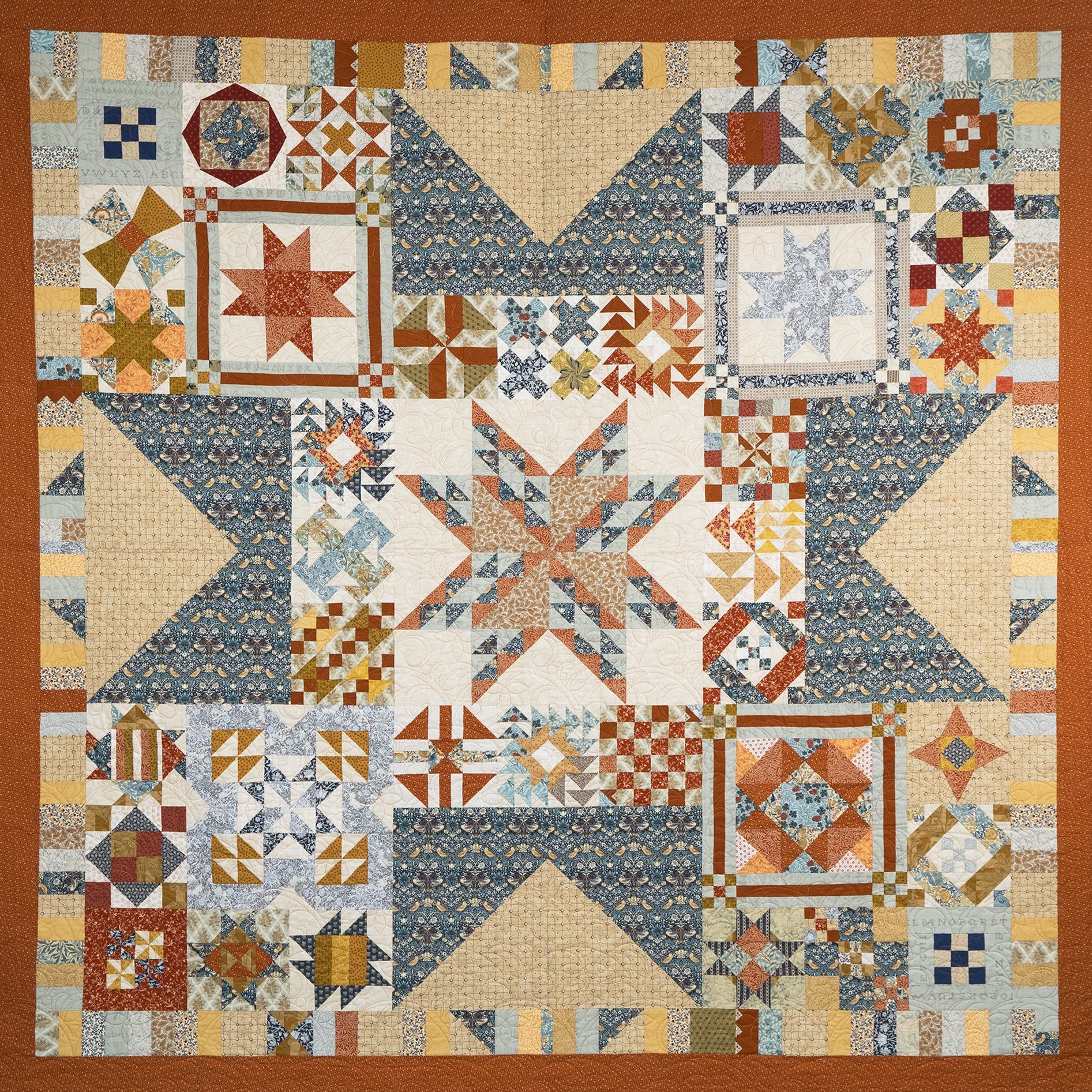 Quilt with geometric pattern in various colors on a brown border