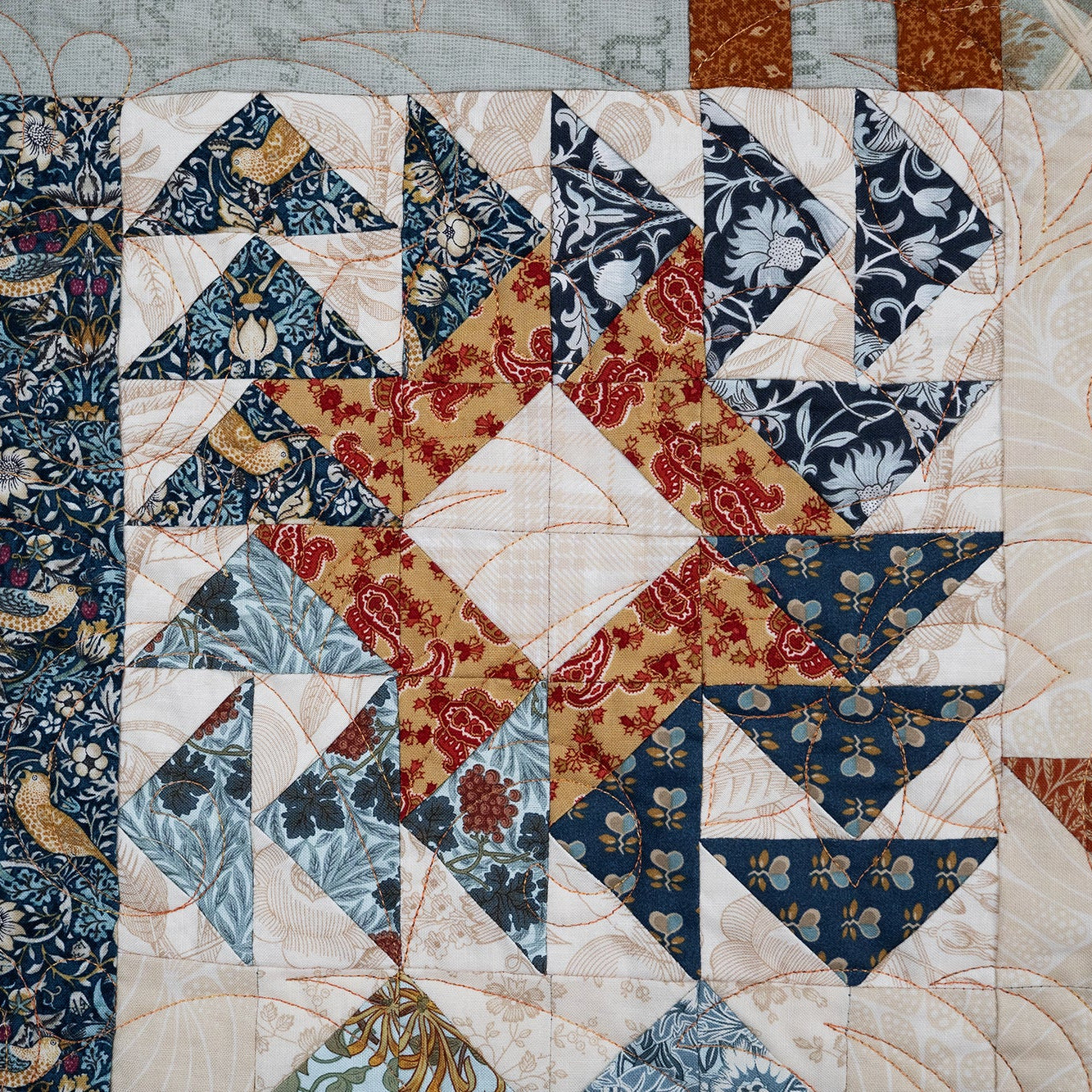 Quilt with intricate patterns featuring a star design.