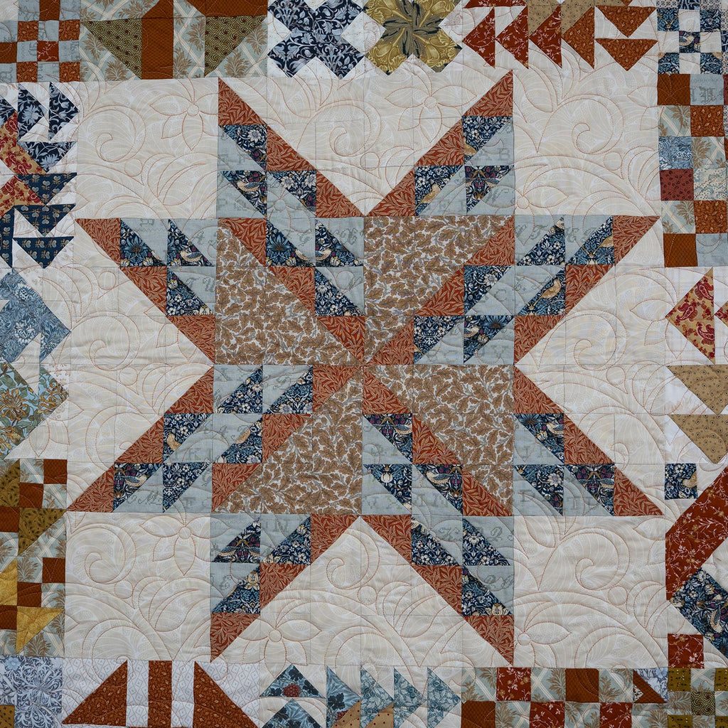 Quilt with geometric pattern in various colors