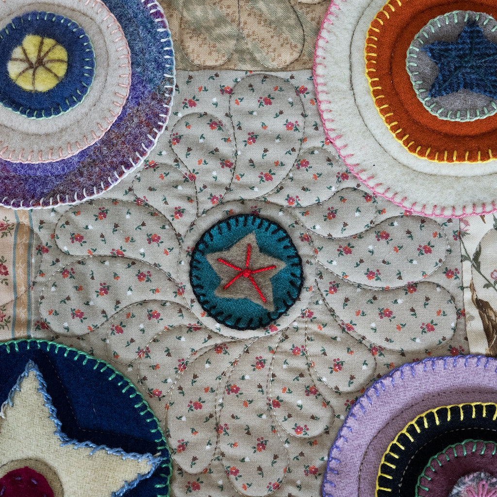Close-up of colorful fabric patches with star designs on a textured background