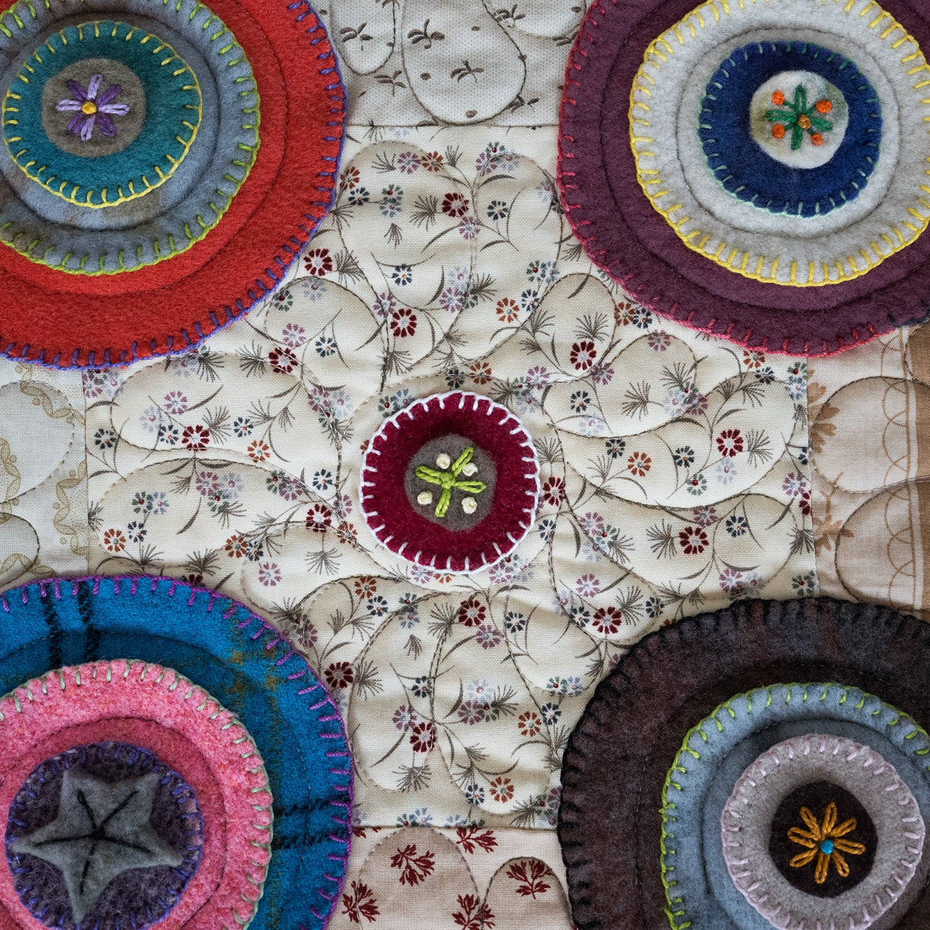 Colorful circular patterns on a textured fabric background