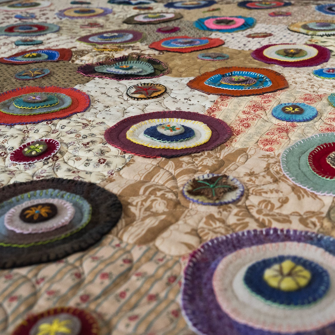 Colorful quilt with circular patterns on a floral background