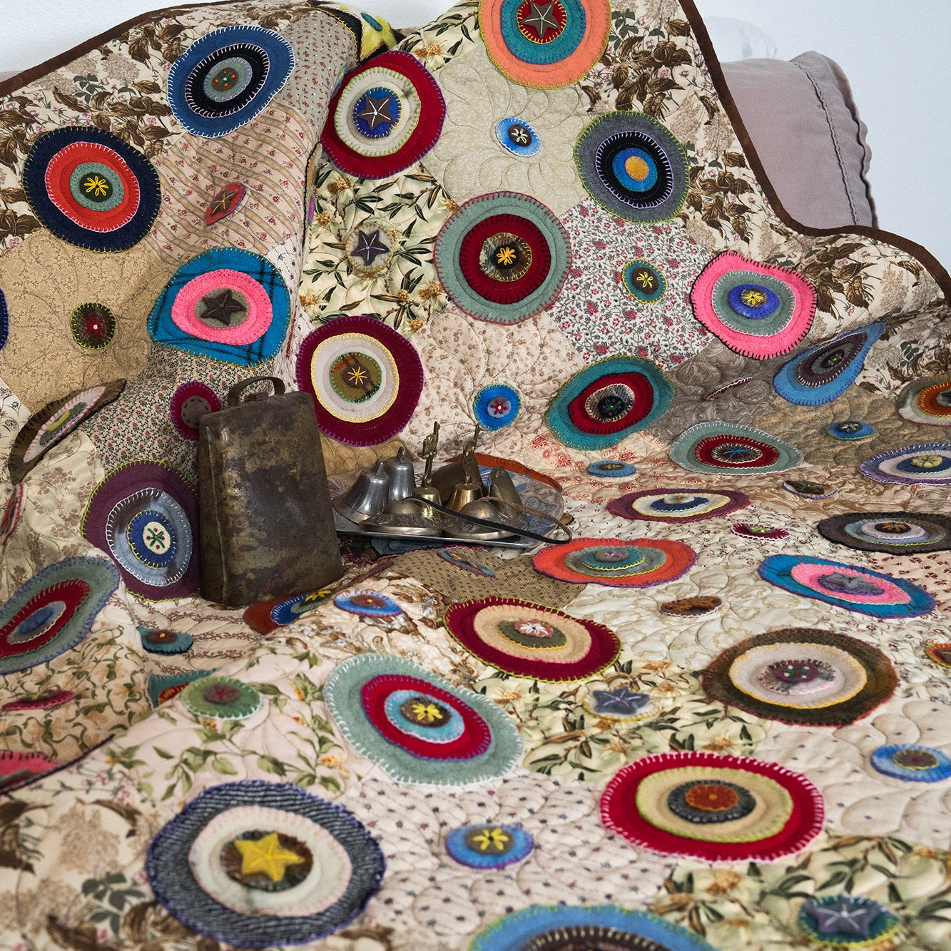 Colorful quilt with circular patterns on a bed
