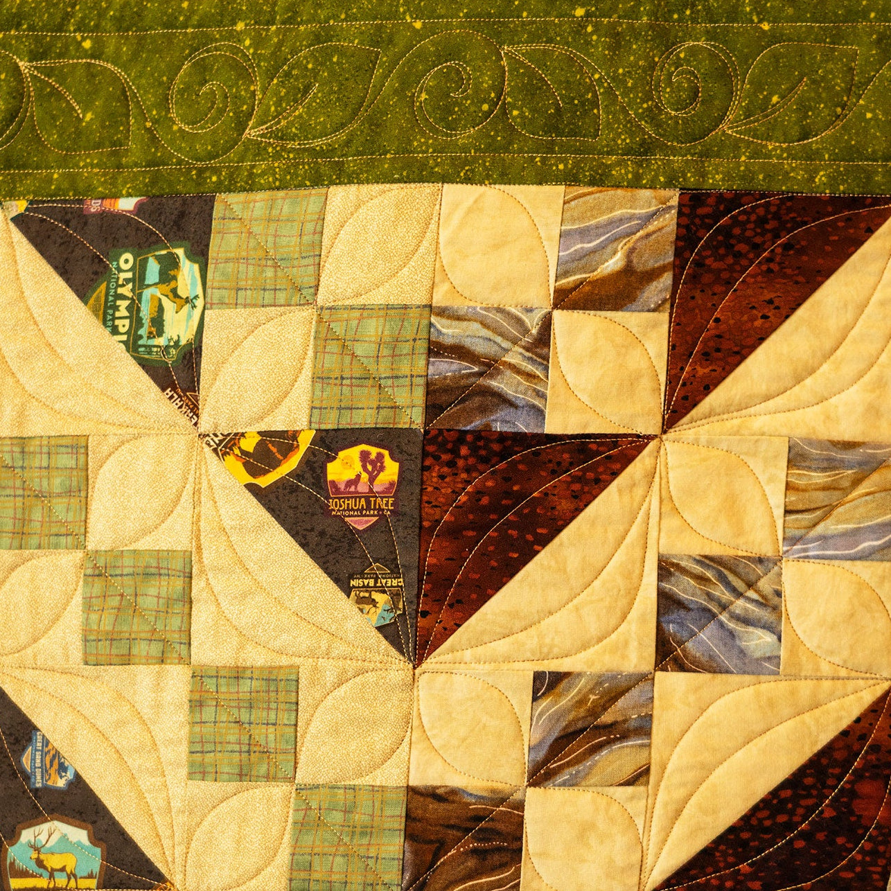 Quilt with patchwork design featuring various colors and patterns.