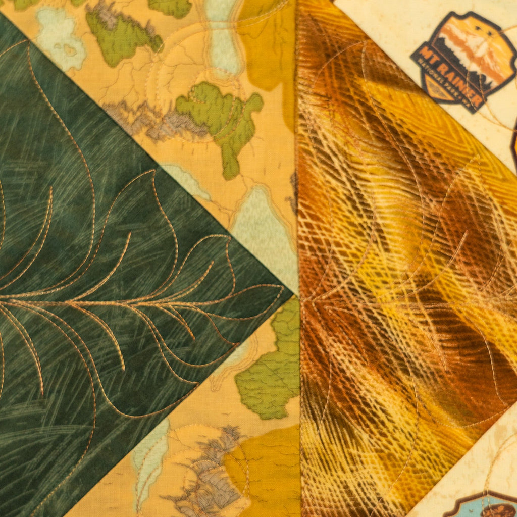 Close-up of a textured fabric with leaf patterns and color swatches.