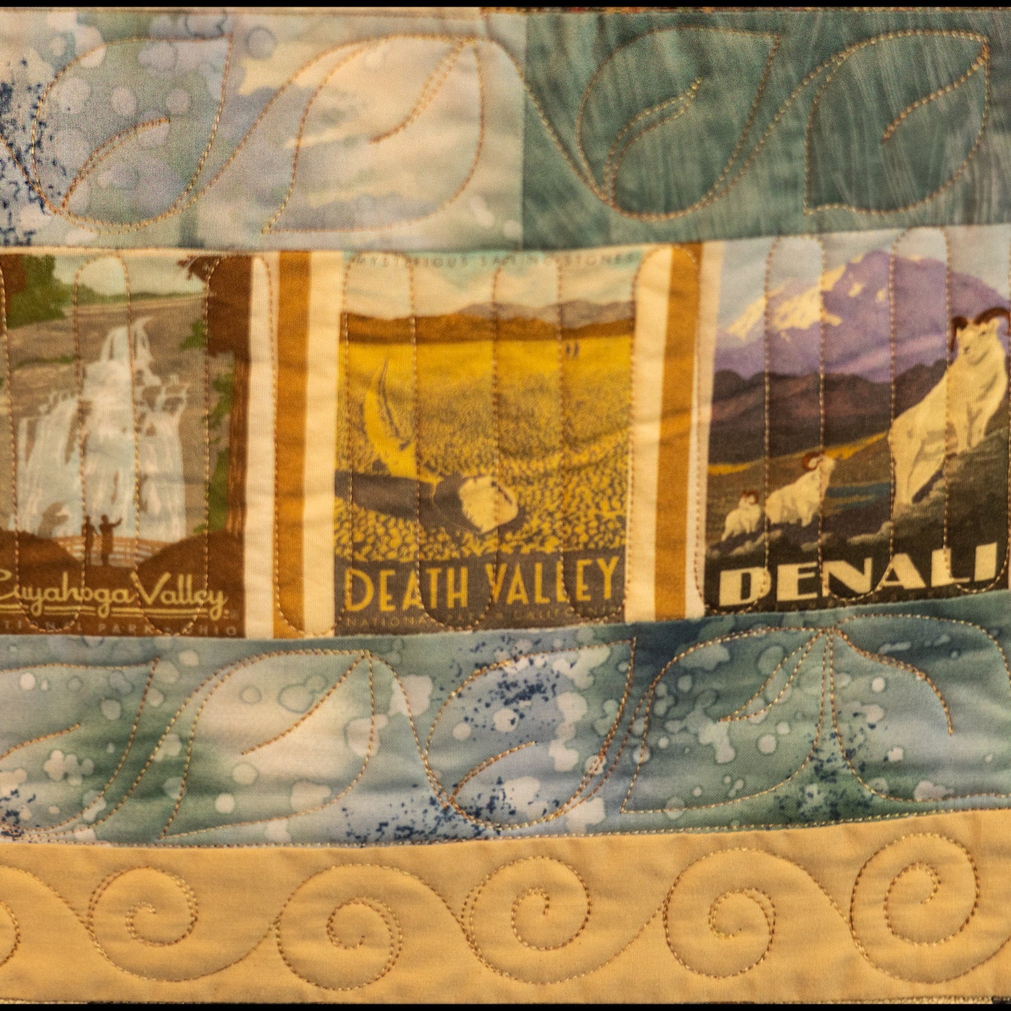Quilted patchwork with scenic images of Cuyahoga Valley, Death Valley, and Denali.