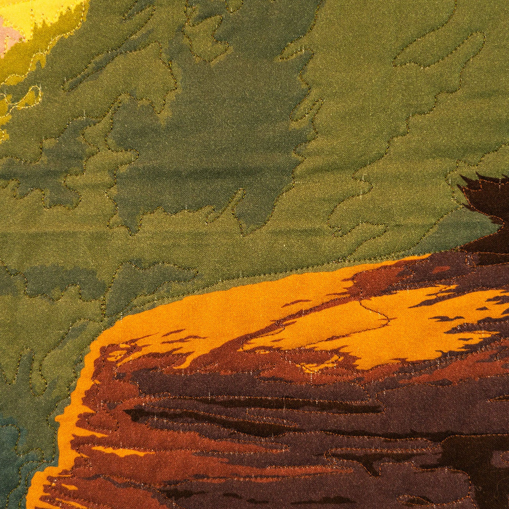 Close-up of a textured fabric with green, orange, and brown colors.