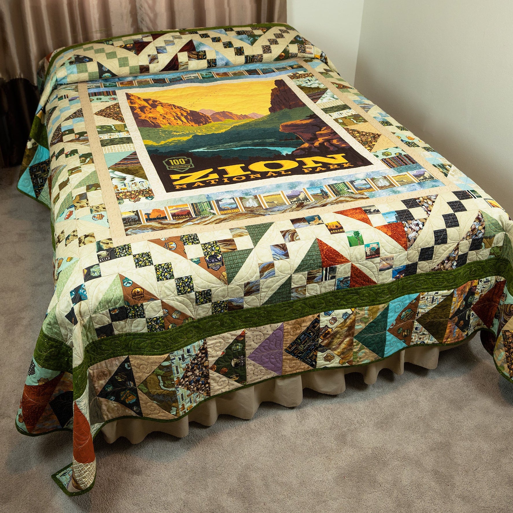 Colorful quilt with scenic design on a bed in a room.